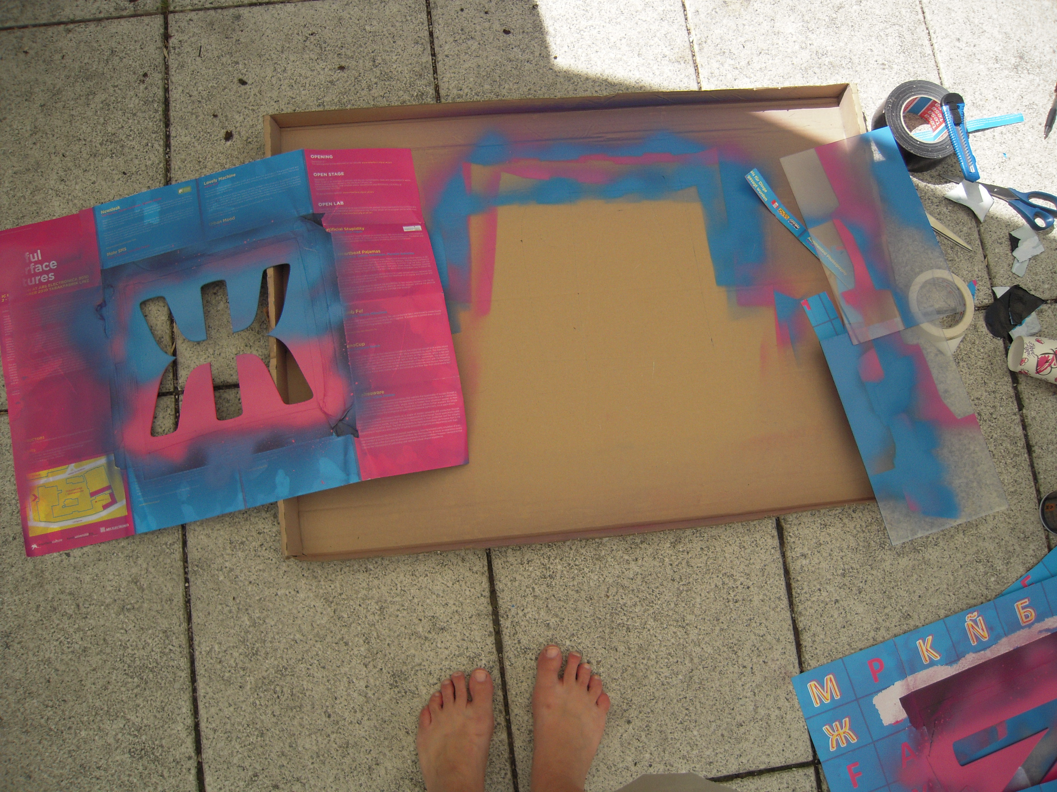 Spraypainting the boxes with stencils